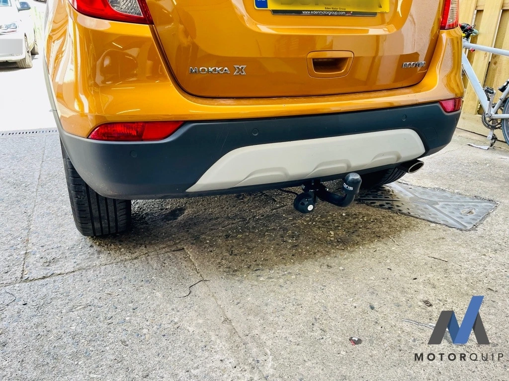 Rear of an orange Vauxhall Mokka showing its fitted towbar