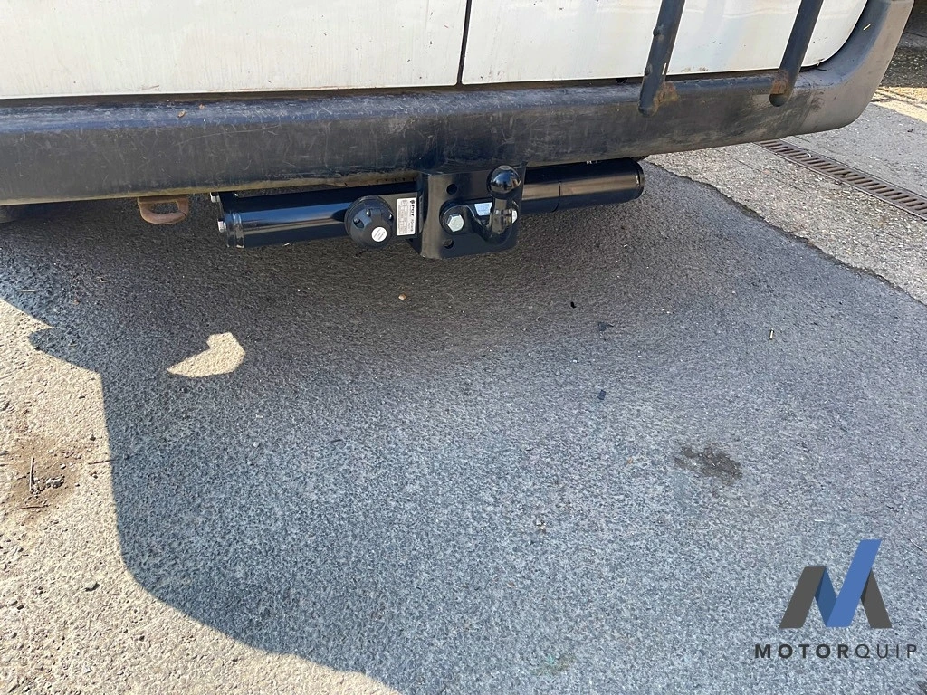 Towbar and electrical socket fitted beneath the rear step of a Ford Transit van