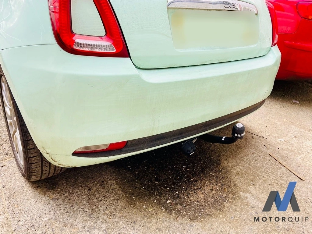 Rear of a pale green Fiat 500 showing its fitted towbar