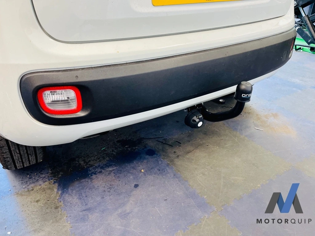 Rear of a white Fiat Panda showing its fitted towbar and electrical socket